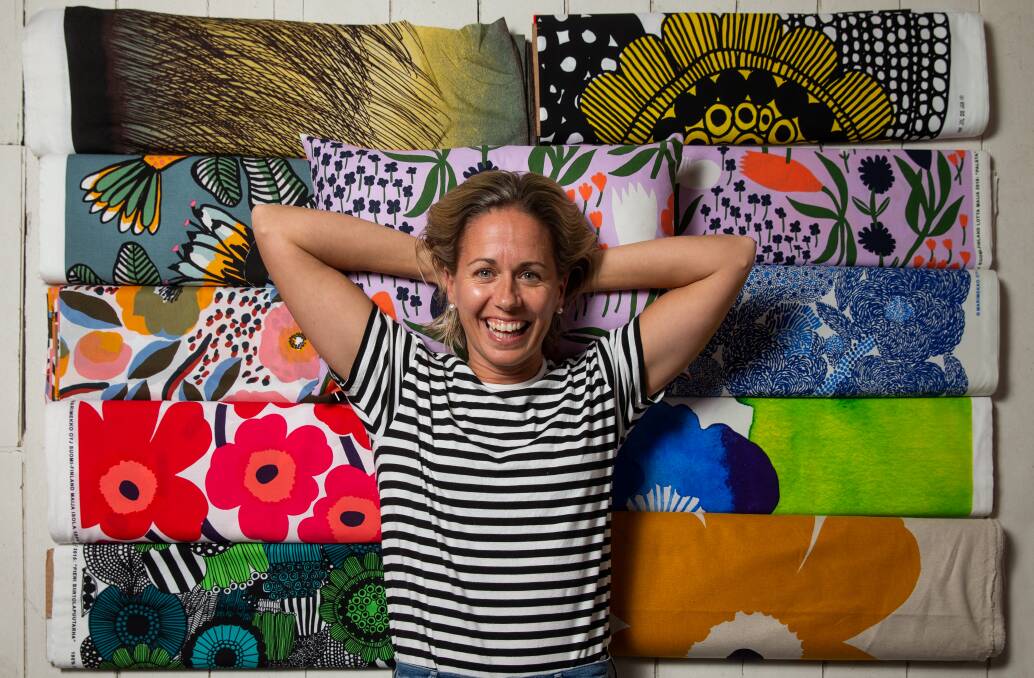 Living in a material world: Pappa Sven owner Libby Helinski with some of the Marimekko fabric which she has used to make face masks and caps for medical staff to use during the coronavirus period. Picture: Marina Neil. 