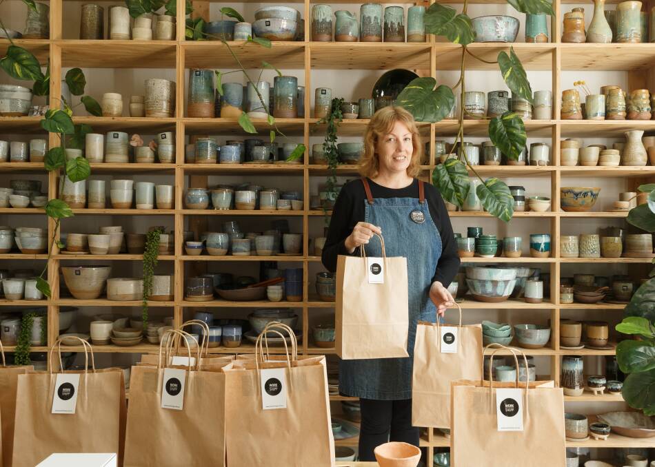 Meditation at work: Simone Madigan in her Workshopp Ceramics studio, with some of her take home clay kits and students' works on the shelves. Picture: Max Mason-Hubers 