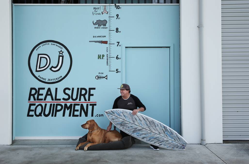 Sweet spot: Surfest concierge and surfboard shaper Dwane Jefferson at his Mayfield West factory, with his dog Arell. Picture: Simone De Peak 
