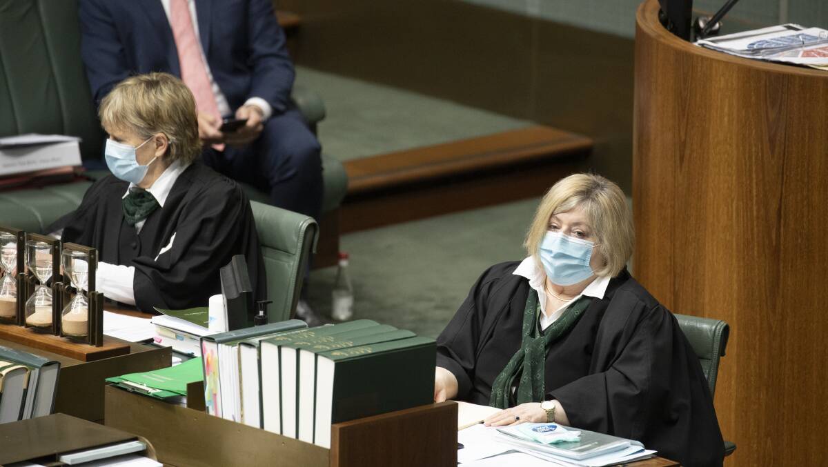 Clerks in the House of Representatives wear masks during question time on Tuesday. Picture: Sitthixay Ditthavong