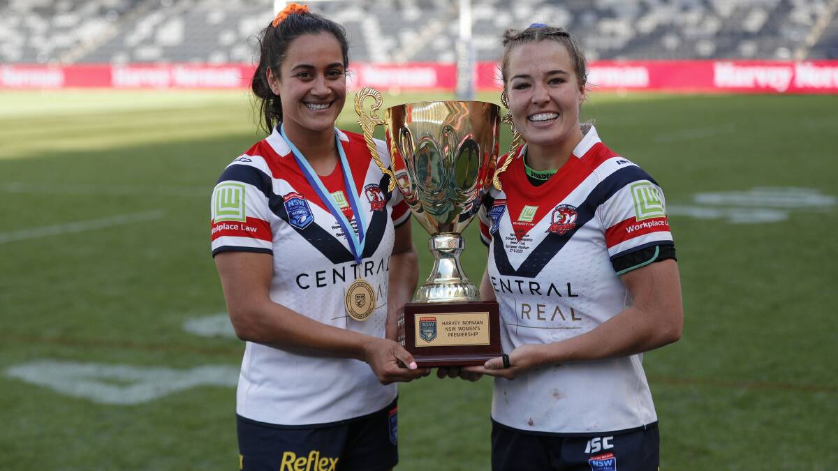 SILVERWARE: Player of the final Yasmin Meakes and Central Coast Roosters captain Isabelle Kelly with the NSW Women's Premiership trophy at Bankwest Stadium on Sunday. Picture: Bryden Sharp