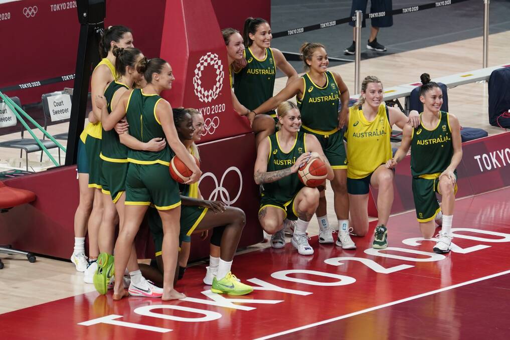 TOGETHER: The Opals squad, including Newcastle pair Leilani Mitchell and Katie Ebzery, in Tokyo on Saturday. Picture: AP Photo/Eric Gay