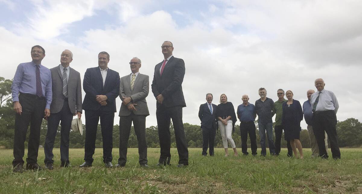 PROMISES: Officials gathered on Thursday at the proposed Lake Macquarie site for a new $25 million indoor sports centre. Picture: Josh Callinan
