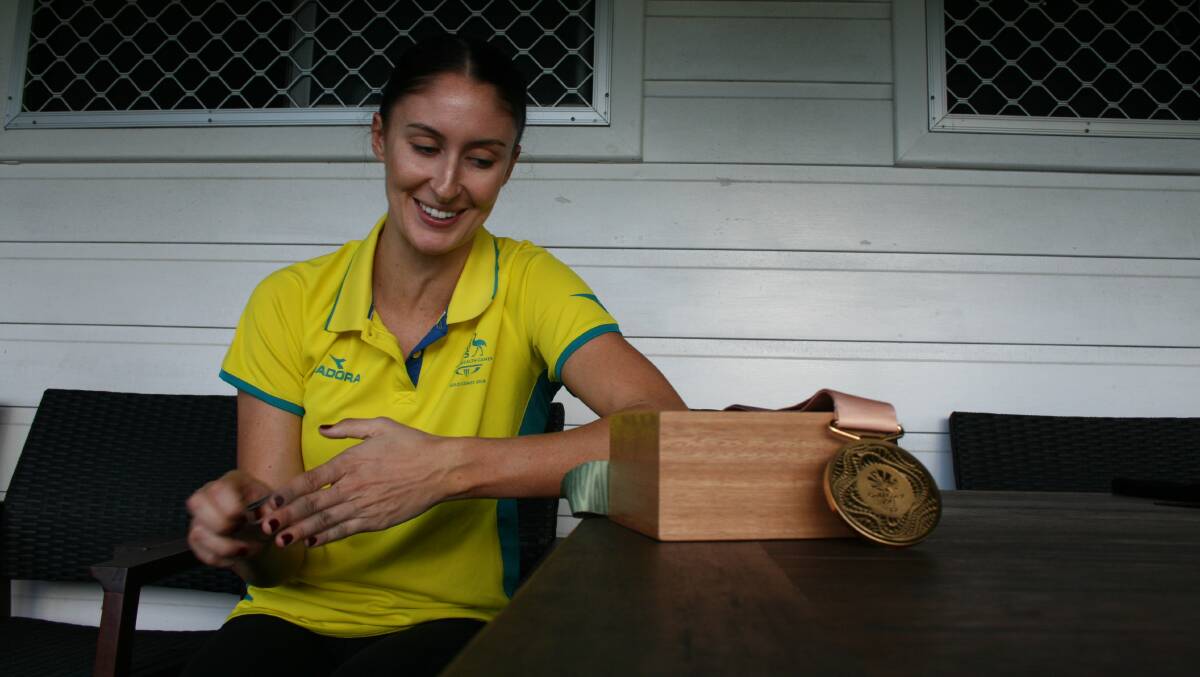 SUCCESS: Katie Ebzery at home in Charlestown after claiming a Commonwealth Games gold medal on the Gold Coast in April. Picture: Josh Callinan