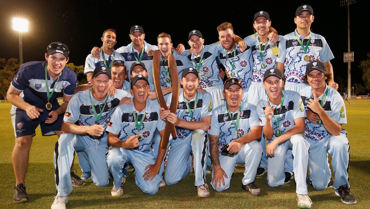 WINNERS: Wallsend's Nathan Price (third from left at front) holds the trophy after NSW claimed the National Indigenous Championships in Alice Springs on Monday. Picture: Twitter via Cricket NSW
