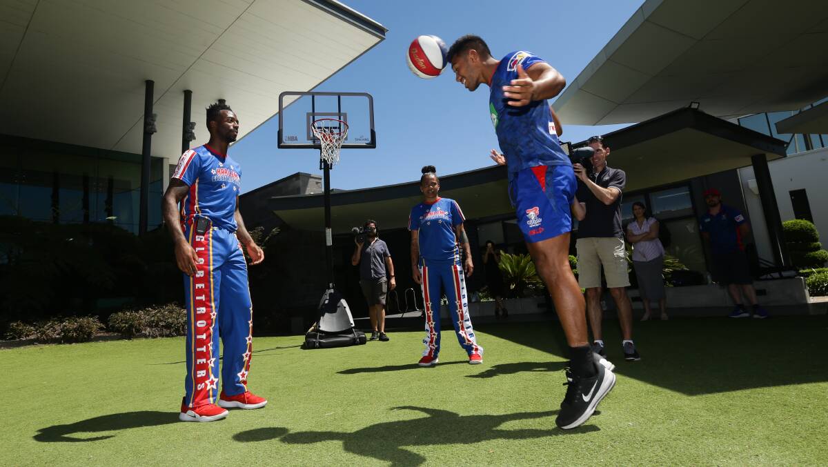 TRICK SHOT: Hymel Hunt heading a basketball with the Harlem Globetrotters in Newcastle on Monday. Picture: Jonathan Carroll