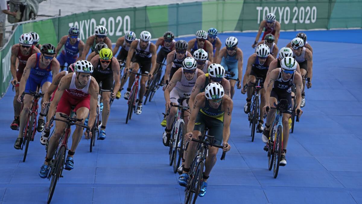 FRONT AND CENTRE: Newcastle triathlete Aaron Royle leads the chase group midway through the bike leg at the Tokyo Olympics on Monday. Picture: AP Photo/Jae C. Hong