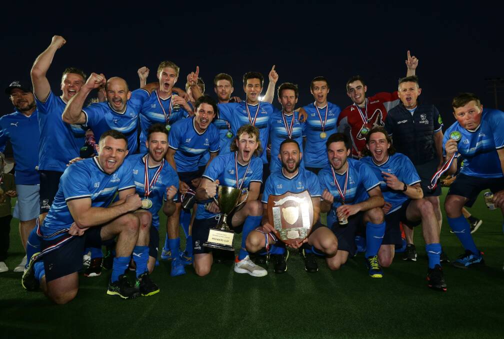 Norths celebrate with the men's Hunter Coast Premier Hockey League silverware after Saturday's epic grand final against Gosford. The Blues beat the Magpies 4-3 at Newcastle International Hockey Centre. Picture by Jonathan Carroll.