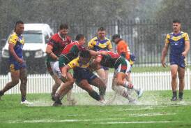 Western Suburbs players defending in heavy rain at Cahill Oval on Saturday. Picture by Peter Lorimer