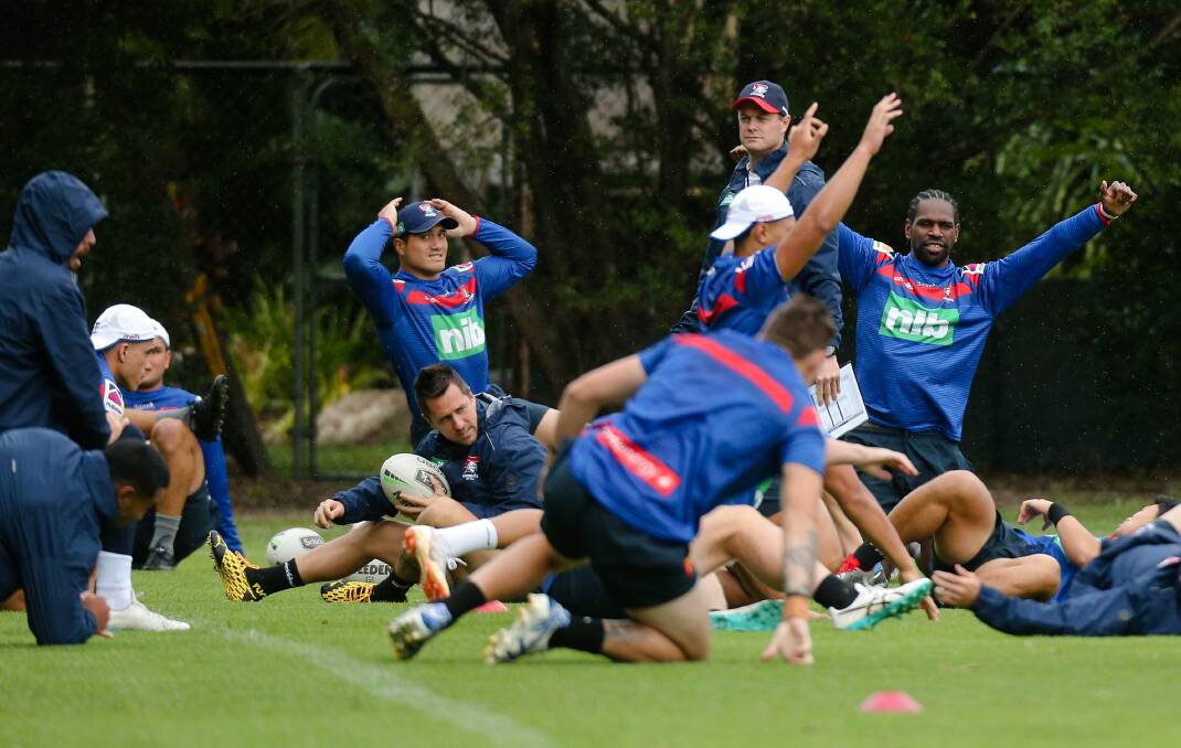 BEND AND STRETCH: Newcastle Knights players train in the rain at Wests Mayfield on Monday ahead of this week's NRL season resumption. Picture: Max Mason-Hubers