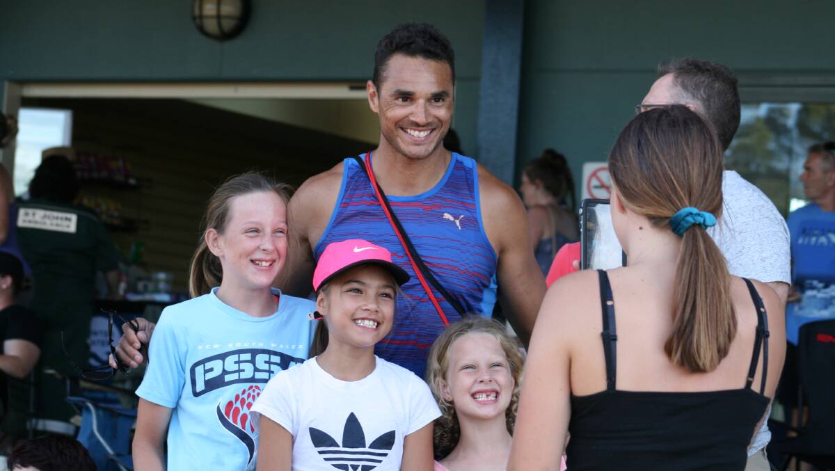 COMEBACK: Two-time Olympian Josh Ross poses for a photo with young fans at last weekend's Hunter Track Classic. The 36-year-old has returned to training with an eye towards claiming a third Stawell Gift in 2019. Picture: Josh Callinan