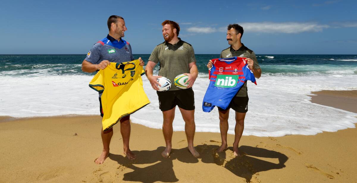 CROSS CODES: Homegrown Wallabies pair Harry Johnson-Holmes (centre) and Nic White (right) with recently re-signed Knights playmaker Blake Green at Merewether ahead of this weekend's rugby union Test at McDonald Jones Stadium. Picture: Jonathan Carroll