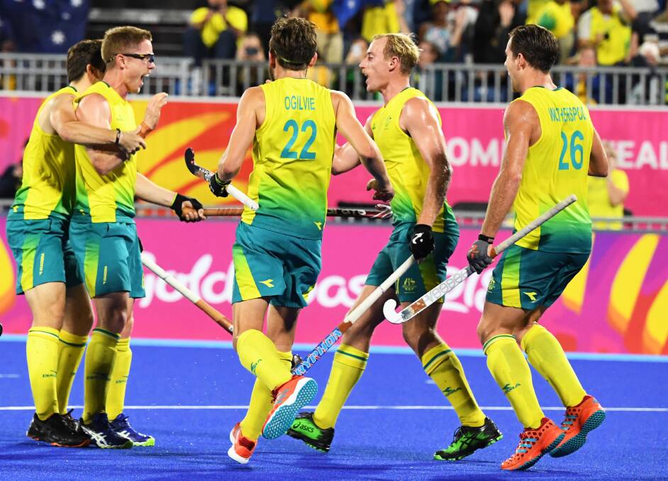 VICTORY: Norths hockey player Matt Dawson (second from left) celebrates with Kookaburas teammates after scoring a goal in Saturday night's Commonwealth Games gold-medal match on the Gold Coast. Picture: AAP
