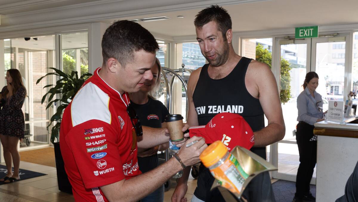 POPULAR: Newly crowned Supercars champion Scott McLaughlin signs an autograph for a fan in Newcastle on Monday morning. Picture: Mark Horsburgh 