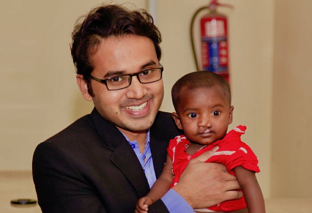 FACE OF CHANGE: Operation Cleft Australia ambassador Moinul Islam with a Bangladeshi infant operated on through the organisation's work, which has funded around 13,000 cleft lip and cleft palate surgeries.