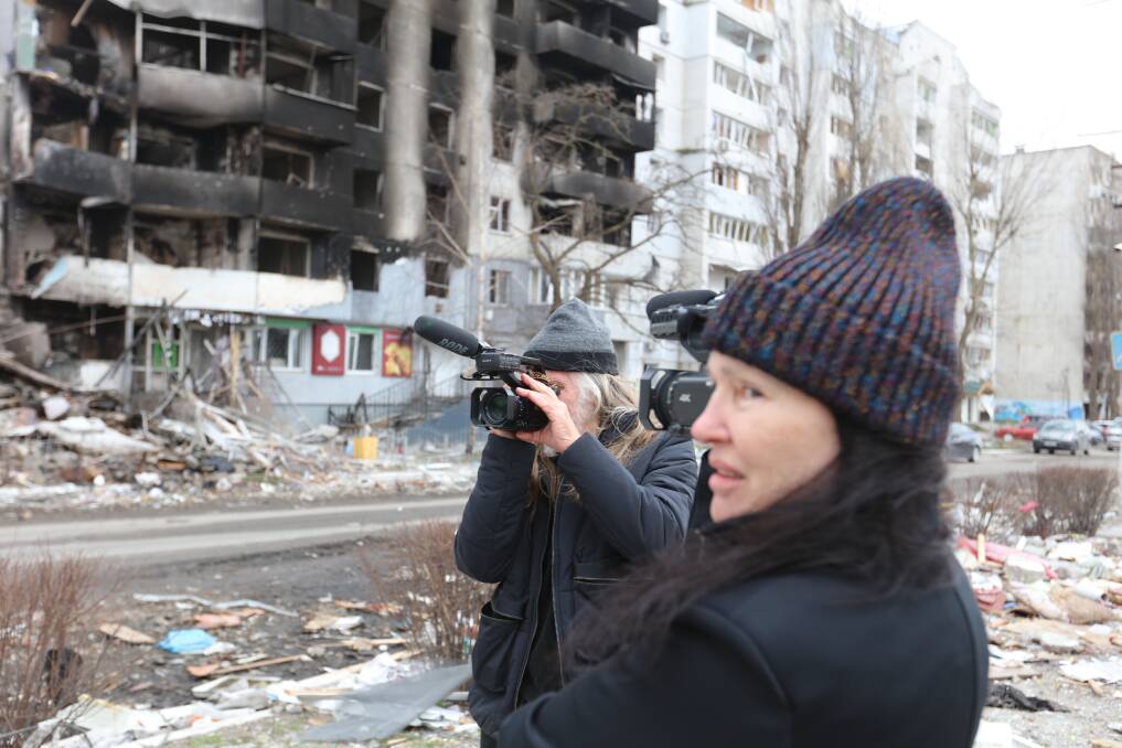 Rose and Gittoes documenting the damage to offices and apartments by indiscriminate shelling and missile strikes.