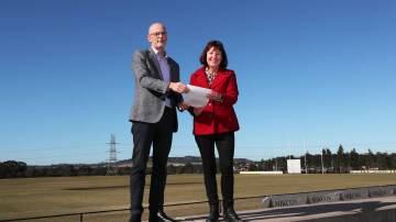 WATER SAVE: Hunter Water managing director Darren Cleary and Lake Macquarie City Council mayor Kay Fraser at the Pasterfield Sports Complex. Picture: Peter Lorimer