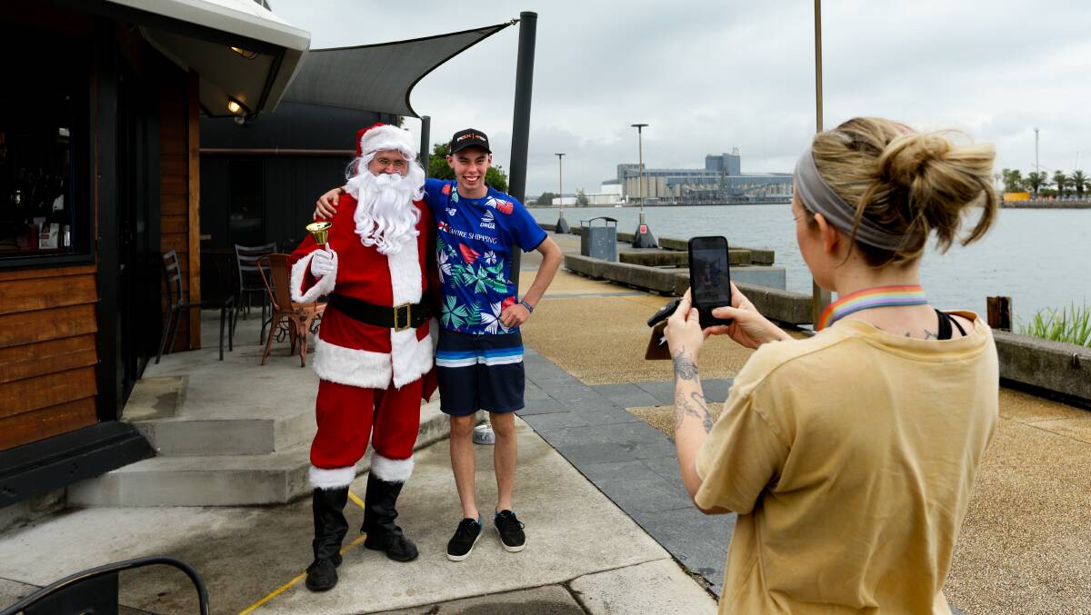 Lynch's Hub owner Blake Forrester dressed as Santa with Isaac Tomkins. Picture by Jonathan Carroll 