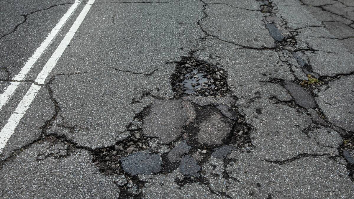 Roads have begun to crumble across Newcastle, including this pothole on Lambton Road at Waratah. Picture by Marina Neil.