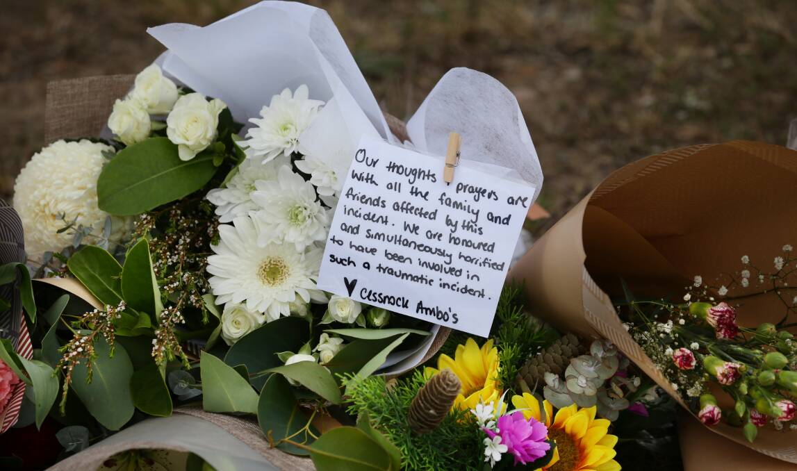 Floral tributes and messages for victims have been left on Wine Country Drive near the site of the bus crash. Picture by Simone De Peak 
