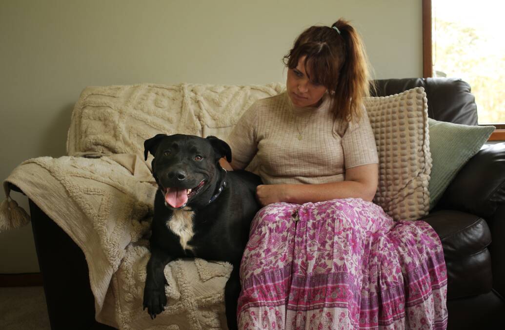 Forster resident Jessica Munro with the family dog, Theo, who became the victim of a baiting attack. Picture by Simone De Peak