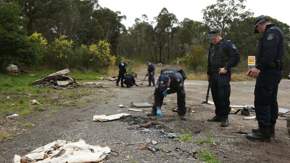 Police investigating a bikie-related shooting search for clues in August at a dumping ground at Freemans Waterhole. Picture by Simone De Peak 
