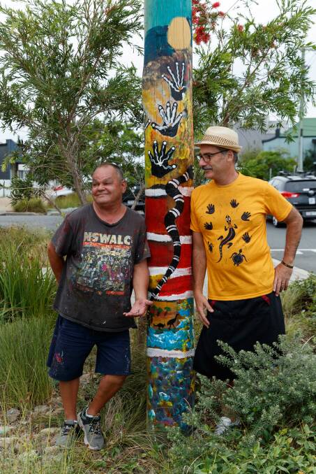 Uncle Billy Lamb with a telegraph pole he has painted and Franky's Dumpings and Noodles owner Matthew McFarlane. Picture by Max Mason-Hubers.