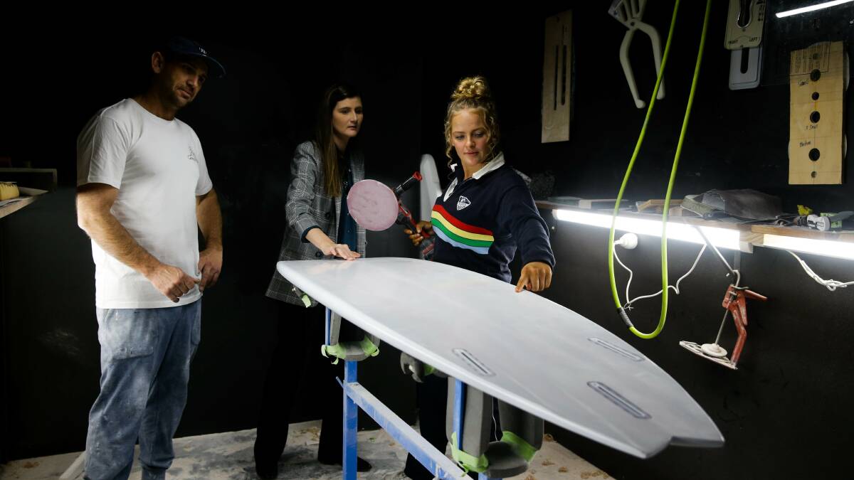 WORK IN PROGRESS: JCD Surfboards owner Jamie Carr, Year 12 student Georgia King and her project teacher Louise Hemsworth. Picture: Jonathan Carroll 