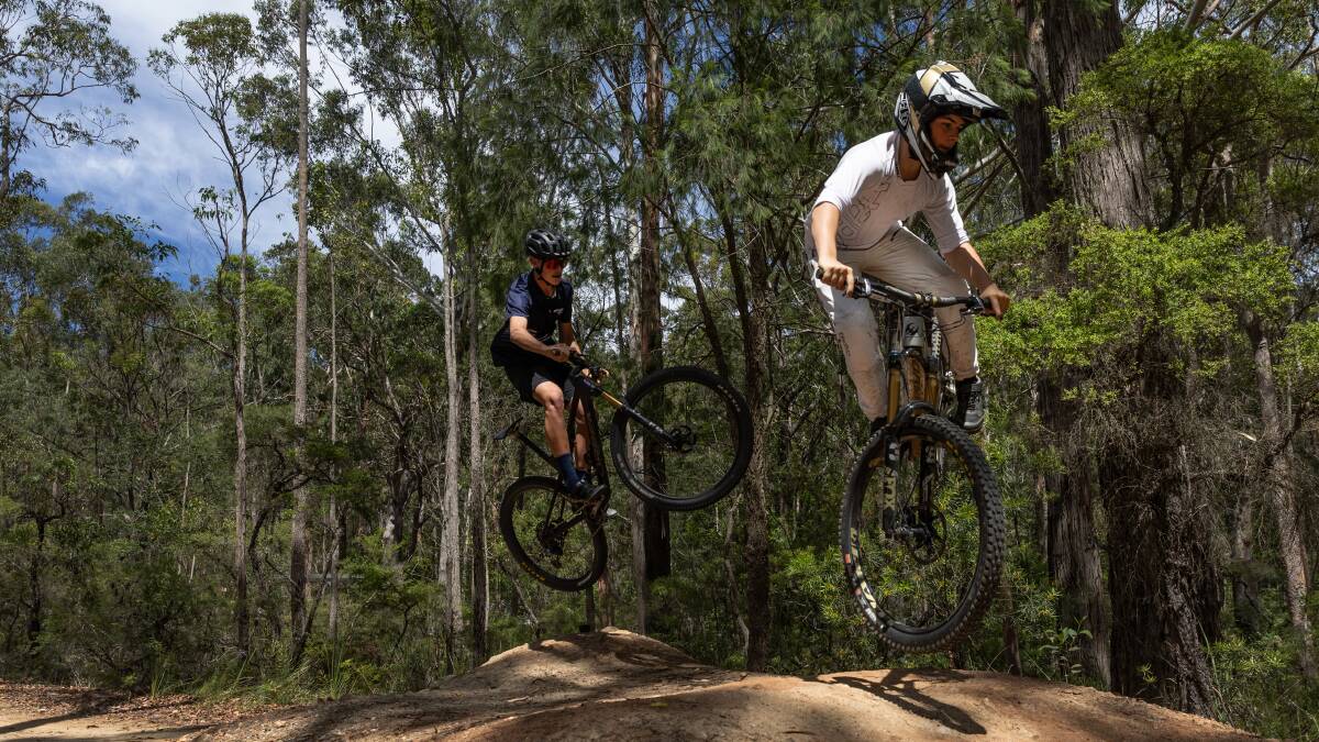 Archie Gibson, 15, and Oscar Berry, 14 show off their talent at the Awaba Mountain Bike Park. Picture by Marina Neil 