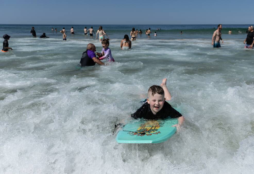 Keith Tangye, 8, caught some waves on his boogie board on Sunday at Nobby's Beach. Picture by Marina Neil 