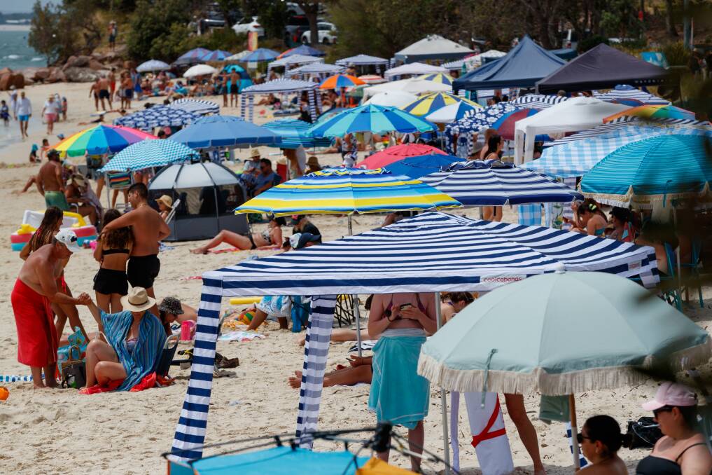 Port Stephens resembles a European summer with hundreds of beach umbrellas lining its shores. Picture by Max Mason-Hubers.