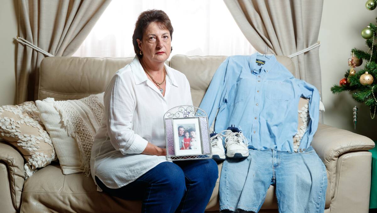 Karen Radford holding clothing similar to what her partner John Davidson was wearing when he went missing. Picture by Max Mason-Hubers.