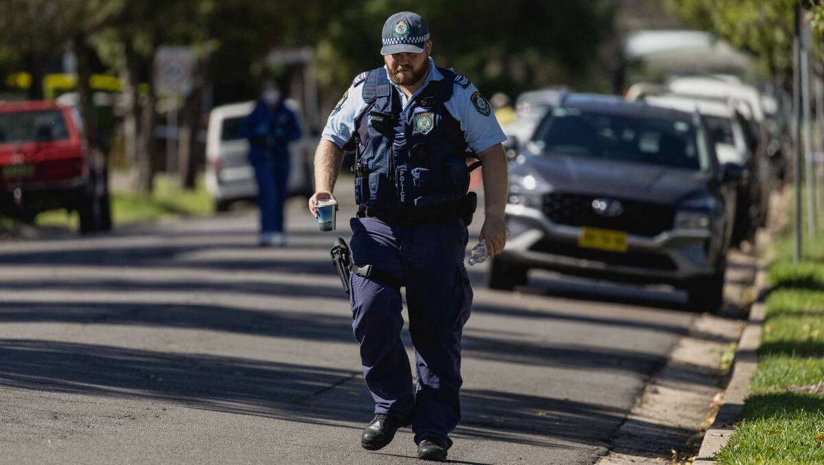 Police combed a quiet Lambton street for clues on Friday morning. Picture by Marina Neil 