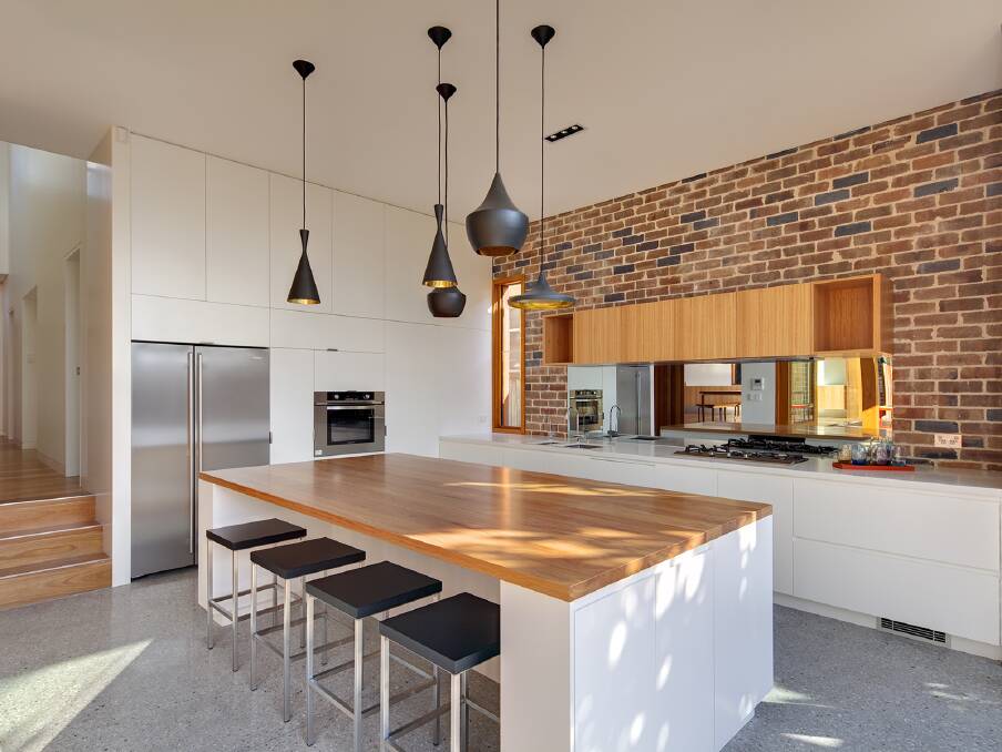 The focal point of the kitchen is a laminated blackbutt island bench. Photo: Murray Fredericks and Simon Whitbread 