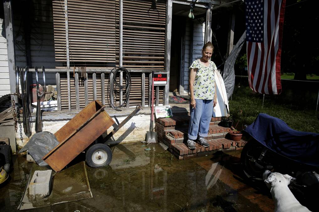 NOT THE WORST OF IT: Connie Sollars amid west Tulsa flooding in May. Oklahoma has recorded 35 tornadoes in 2019 so far. 
