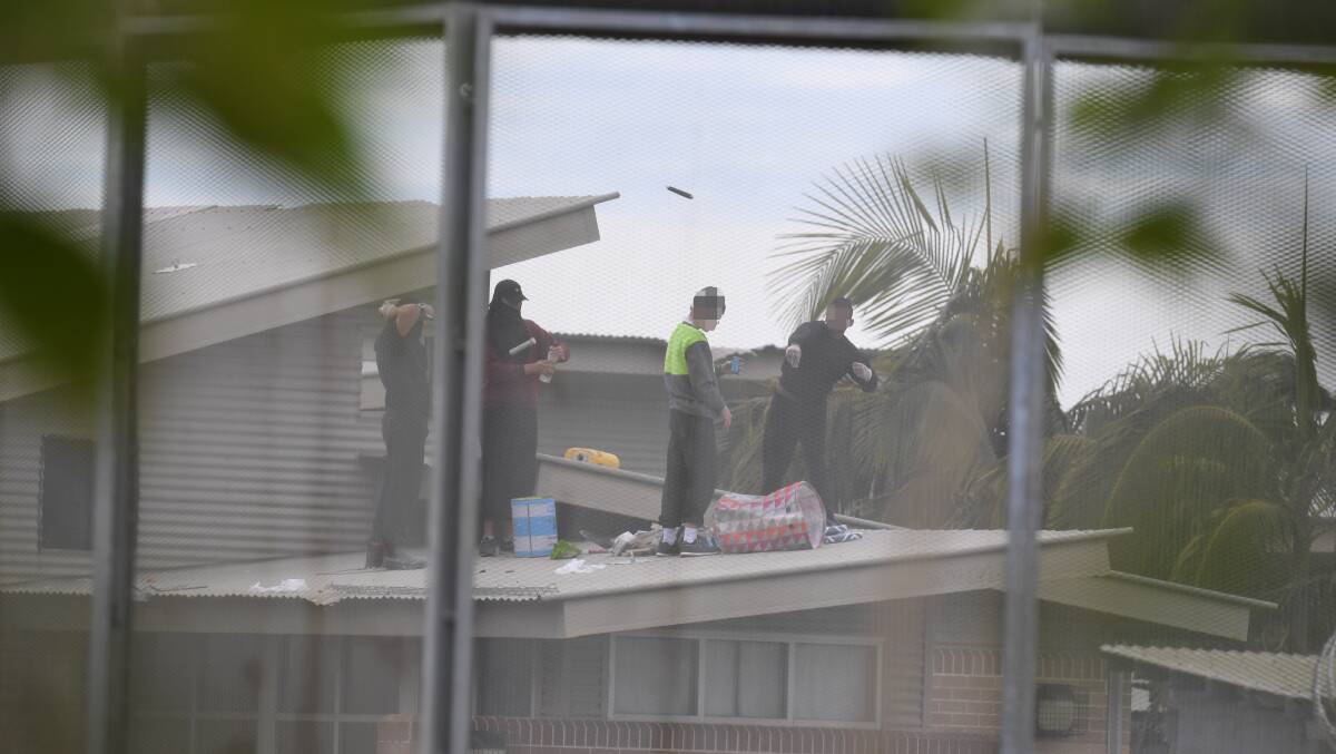 ONGOING: Police negotiators are working on Monday to coax inmates down from the roof of the facility. Picture: AAP