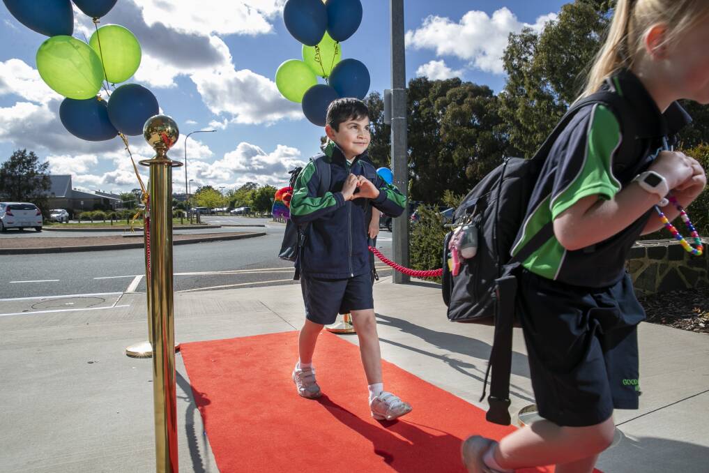 WE'VE ARRIVED: Good Shepherd Primary School rolls out the red carpet for student Andy Castendad-Alas and friends. Picture: Keegan Carroll