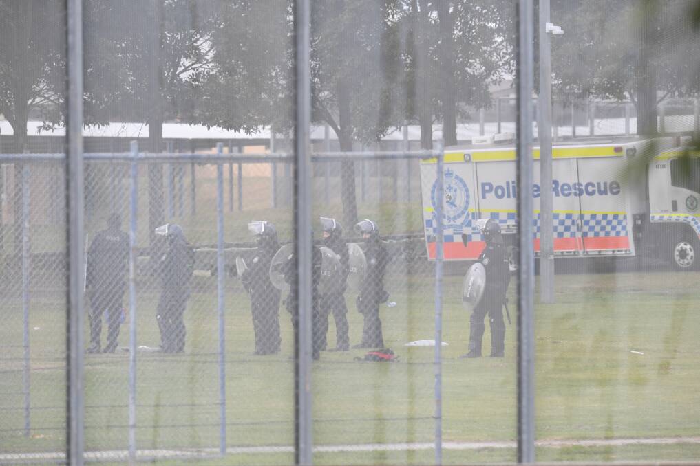 STAND-OFF: Police outside the Kariong juvenile justice centre on Monday. Picture: AAP