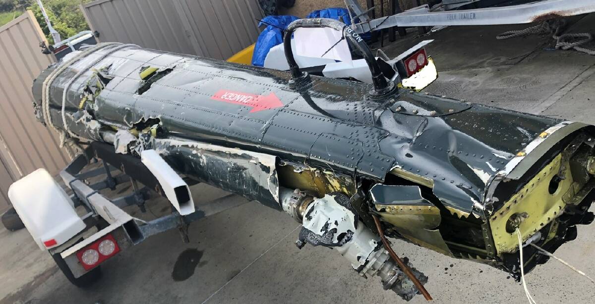 REMNANT: A tailboom section of the helicopter retrieved from waters off Anna Bay. Picture: NSW Police