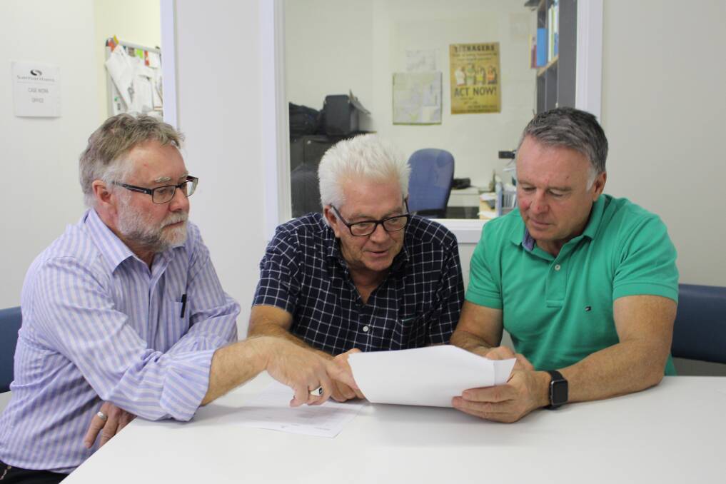 CASHING THEM OUT: Federal Hunter MP Joel Fitzgibbon with John Barham, Intensive Support Worker at the Samaritans Foundation, and financial counsellor Graham Smith discussing the impact of the loans. 