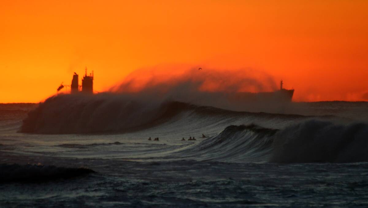 SHIP SHAPE: Waves obscure a dawn departure. Picture: Dave Anderson