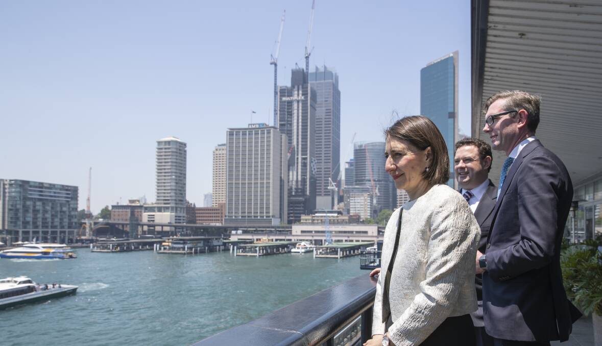 ADJUSTING: Premier Gladys Berejiklian, Minister for Jobs, Investment, Tourism and Western Sydney Stuart Ayres and Treasurer Dominic Perrottet at Thursday's announcement that lockout laws would be repealed for Sydney's CBD. They will remain in force in Kings Cross. Picture: Louie Douvis