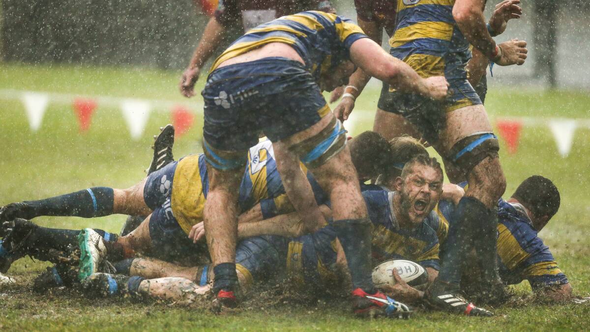 DRY YOUR EYES: Hamilton Hawks' Liam Bowen scores during a June NHRU match against Lake Macquarie amid torrential rain. Picture: Marina Neil