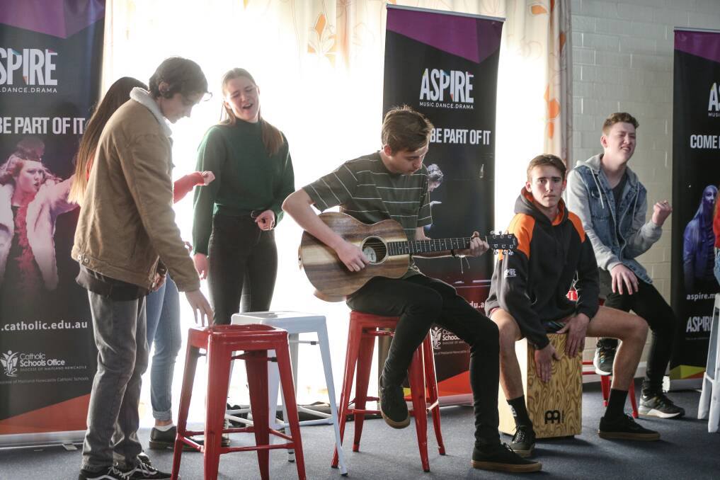PLAYING TO THE CROWD: Students run through some of the upcoming Aspire production 365 Questions, Issues and Good Deeds for the residents at St John's Villas in New Lambton on Wednesday. Picture: Marina Neil