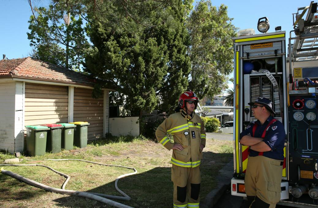 SMOKED: Firefighters at the scene of the early morning fire. Neighbours said the fire began with a "massive fireball" about 4am on Monday. Picture: Simone De Peak