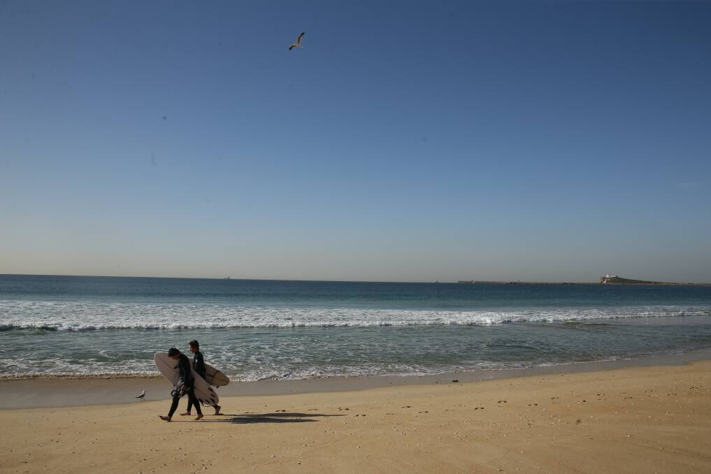 BREAK POINT: Surfers on Stockton beach. Reader Simon Jones says improving the surf quality at the coastal stretch could deliver a tourism boon to Newcastle.