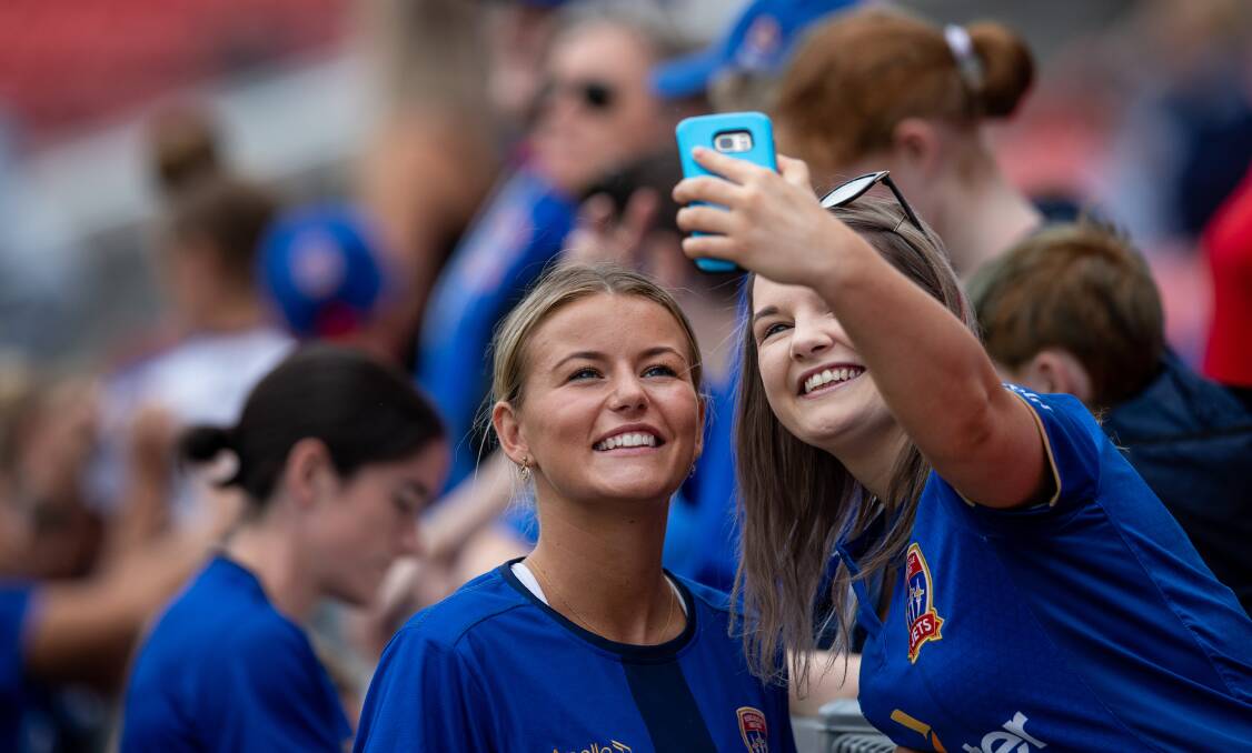 Newcastle striker Sophie Harding gets a selfie with a fan at a Jets members day in pre-season. Picture: Marina Neil