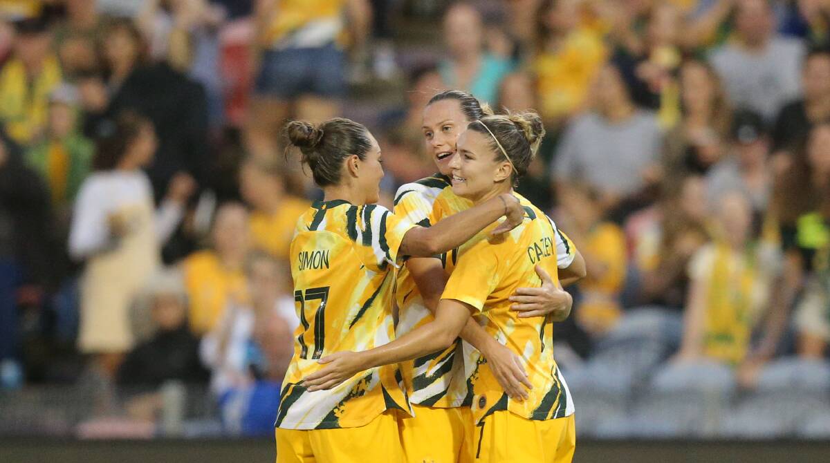 Matildas Kyah Simon and Steph Catley congratulate Newcastle's Emily van Egmond on her goal in a 5-0 win over Vietnam at McDonald Jones Stadium in March 2020. Picture: Max Mason-Hubers