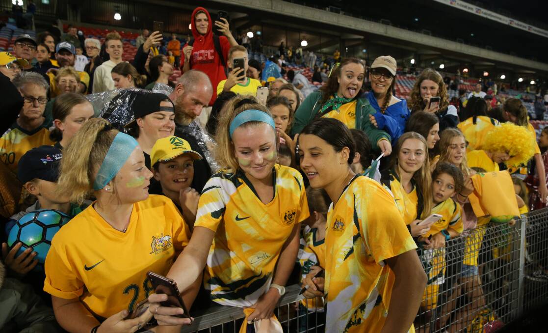 CROWD-PLEASER: Matildas captain Sam Kerr poses with fans after Australia played Vietnam at McDonald Jones Stadium in March of last year. Picture: Max Mason-Hubers