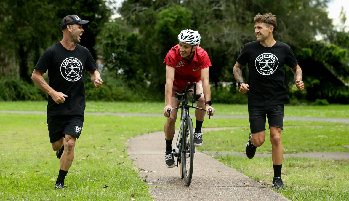 From left, Nathan Stewart, Hamish Longmuir and Ben Maunder share a laugh during the week before vying for victory in the Sparke Helmore Triathlon at Newcastle Foreshore this Sunday. Picture by Jonathan Carroll